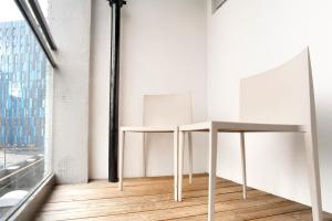 a rendering of two tables in a room with a window at Sandman Signature Newcastle Hotel in Newcastle upon Tyne