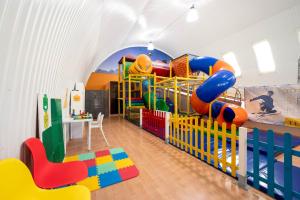 a room with a play room with a playground at Albatros Spa & Ski in Jarosławiec