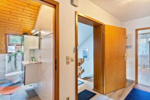 a bathroom with a toilet and a sink and a door at Haus Günter und Valeria in Gossersweiler-Stein +23 photos