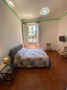 a bedroom with a bed and a table and a window at Morgagnigd in Florence