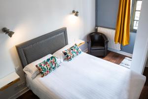 Postel nebo postele na pokoji v ubytování Hotel Le Port Neuf
