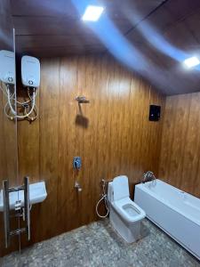a bathroom with a toilet and a sink and a tub at Pawna Resort in Lonavala