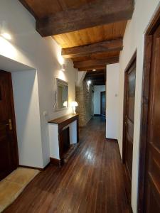 an empty hallway with wood floors and a mirror at Le Moulin de Bernard in Saint-Pantaléon