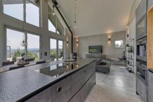 a kitchen with two sinks and a living room at Chalet Panorama in Freyung