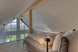 a living room with a couch and a large window at Chalet Panorama in Freyung