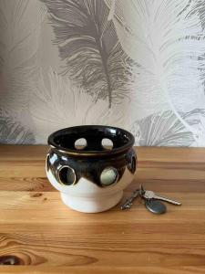 a black and white bowl on a table with a pair of keys at Sunny ROOM in Stockholm in Stockholm
