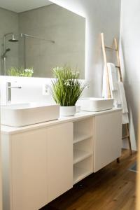 a bathroom with two sinks and a mirror at Azores Green Villas in Ponta Delgada