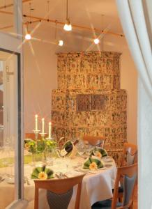 a dining room with a table with chairs and candles at JUFA Hotel Schwarzwald in Lenzkirch