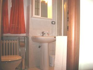 a bathroom with a sink and a toilet at Casa Bruno B&B in Mondovì