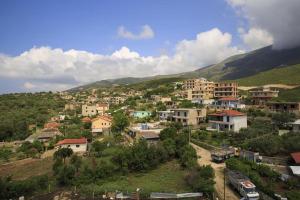 a small town on a hill with houses at 360° View Apartments in Vlorë