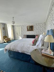 a bedroom with a large bed and a table at Trewardale in Bodmin