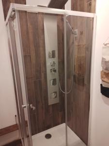 a shower with a glass door in a bathroom at Casa Vacanze MURANUM - B&B in Morano Calabro