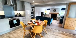 a kitchen and dining room with a table and chairs at Central Ripon apartment - view of the Cathedral! in Ripon