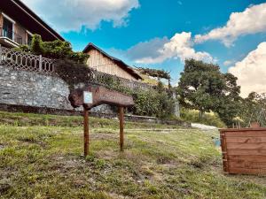 a sign in the grass in front of a building at Au Pied de l'Arcluse, terrasses et jardin - CLG - Savoie Bauges - 2 CH in Chevillard