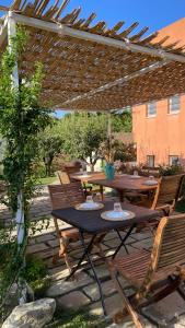 a patio with tables and chairs under a pergola at Bio&B Acquaviva in Otranto