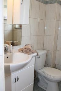 a bathroom with a white sink and a toilet at Apartment Noel in Sveti Vid-Miholjice +35 photos