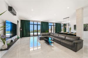 a living room with a couch and a table at Villa Stone house in Novalja