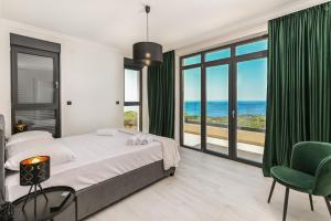 a bedroom with a bed and a view of the ocean at Villa Stone house in Novalja +22 photos
