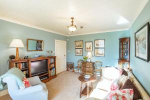 a living room with a couch and a tv at Kenmure Kennels in New Galloway