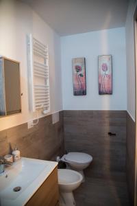 a bathroom with a toilet and a sink and a mirror at QUEEN appartamenti e camere in Campofilone