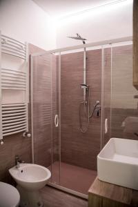 a bathroom with a shower and a toilet and a sink at QUEEN appartamenti e camere in Campofilone