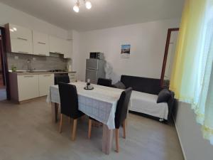a kitchen and a dining room with a table and chairs at Apartment Marta in Jablanac