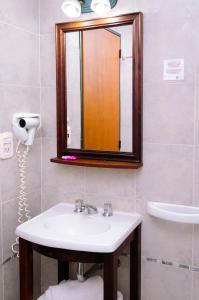 a bathroom with a sink and a mirror at Rosario Suites in Rosario