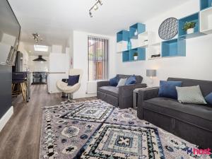 a living room with a couch and a kitchen at Host Liverpool - Cozy CoLiving, Connect & Enjoy in Liverpool