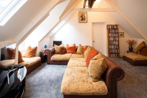 a living room with a couch and a tv at The Crag in Wadebridge