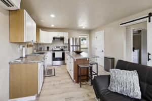 an open kitchen and living room with a couch at Lewiston Vacation Rental Near Clearwater River! in Lewiston