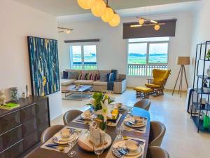 a dining room with a table and chairs and a living room at Luxury Golf View For Family 203A3 in Abu Dhabi
