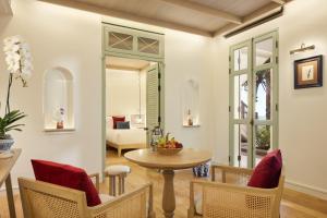 a living room with a table and chairs at CHARRAS Bhawan Hotel and Residences in Hua Hin +76 photos