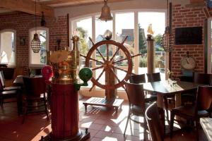 un restaurante con una rueda arbolada en una habitación en Der Speicher, en Wolgast