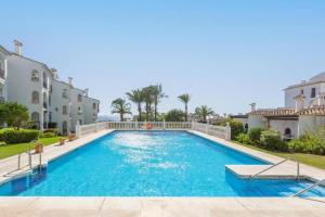 a swimming pool in the middle of a house at 210 Mijas Sea View Bahia Playa in La Cala de Mijas +15 photos