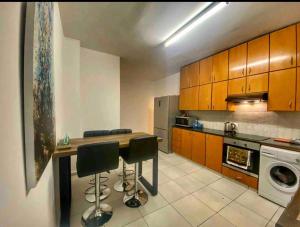 a kitchen with a table and some chairs in it at Modern 3BDR in Acropolis-Nicosia in Strovolos