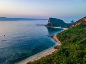 an aerial view of the ocean and a beach at Inlight Lombok Beach Hotel in Kuta Lombok