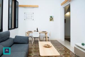 a living room with a couch and a table at Vegueta Old Town, Las Palmas in Las Palmas de Gran Canaria