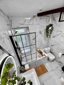a bathroom with a sink and a toilet and a mirror at Large Peak District National Park Holiday House in Hadfield