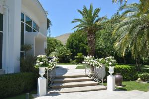 een trap met witte bloemen in witte vazen bij Villa Sirena Hotel e Ricevimenti in Durazzano