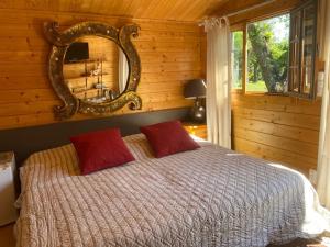 a bedroom with a bed with a mirror on the wall at Villa 55 in Grimaud