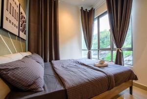 a bedroom with a bed with a large window at Serene Mossy Family Cottage(2-7pax) 10 Min to BOH in Cameron Highlands