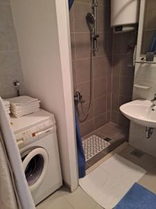 a bathroom with a washing machine and a sink at City, sea and river view, Omis in Omiš