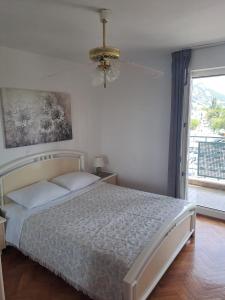 a bedroom with a bed and a large window at City, sea and river view, Omis in Omiš