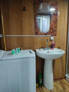 a bathroom with a sink and a mirror at Barybari in Khulo