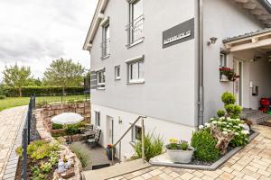 a view of the outside of a building with a patio at Ferienwohnung Alpenblick in Zwiefalten