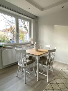 einen Tisch und Stühle in einem Zimmer mit Fenster in der Unterkunft Country style apartment with balcony near fair in Hannover