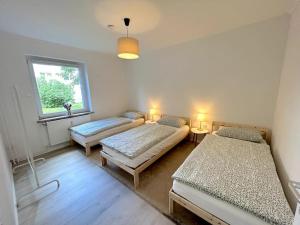 a room with two beds and a window at Country style apartment with balcony near fair in Hannover