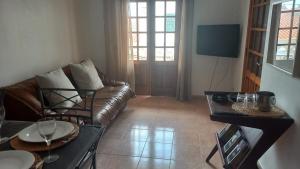 a living room with a couch and a table at Apartamentos Naturalis in Vila Nova de Milfontes