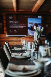 a table with plates of food and wine glasses at Stabburet Madam Meyer in Skage i Namdalen