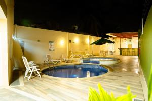 a large swimming pool with chairs and a table at Hotel Isla Bonita in San Andrés